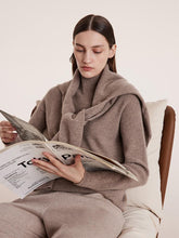 A lady wears a cashmere sweater.